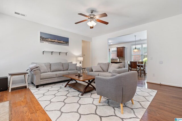 5846 Water Branch Rd, Hoover, AL 35244 - living area featuring a ceiling fan, wood finished floors, and baseboards