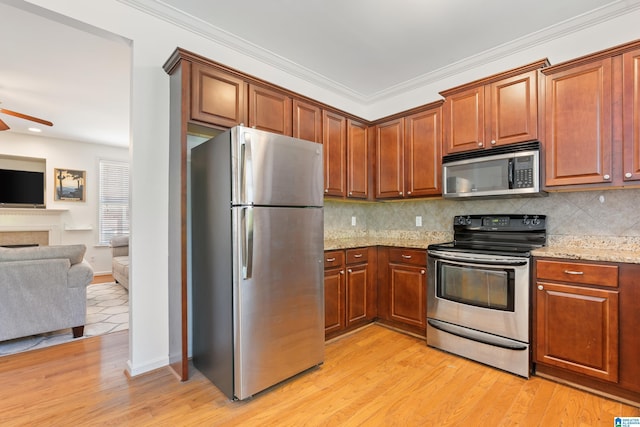 5846 Water Branch Rd, Hoover, AL 35244 - kitchen with appliances with stainless steel finishes, open floor plan, ceiling fan, light stone countertops, and decorative backsplash