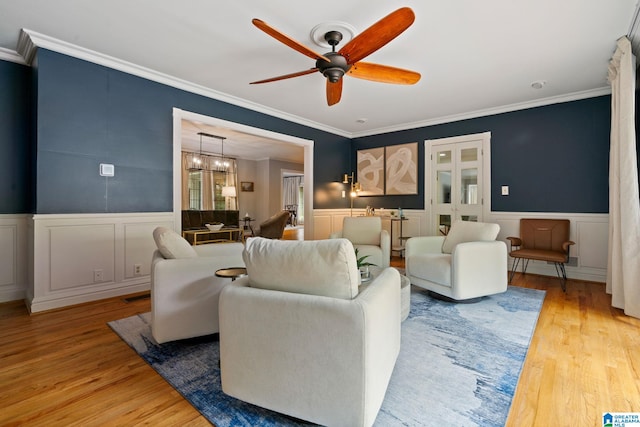 3208 N Woodridge Rd, Mountain Brook, AL 35223 - living area with ornamental molding, wood finished floors, a ceiling fan, a wainscoted wall, and a decorative wall