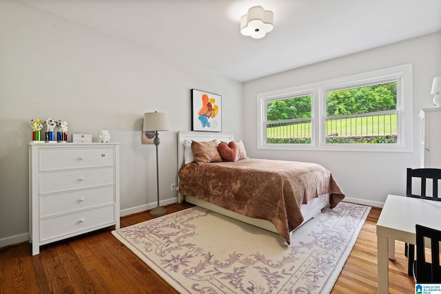 3208 N Woodridge Rd, Mountain Brook, AL 35223 - bedroom featuring baseboards and wood finished floors