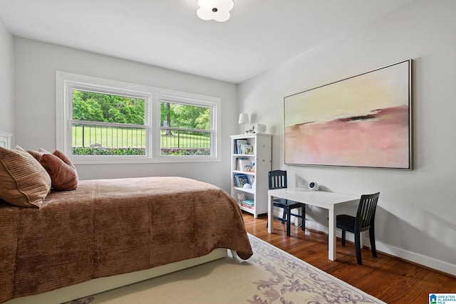 3208 N Woodridge Rd, Mountain Brook, AL 35223 - bedroom featuring wood finished floors and baseboards