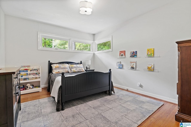 3208 N Woodridge Rd, Mountain Brook, AL 35223 - bedroom with light wood finished floors and baseboards