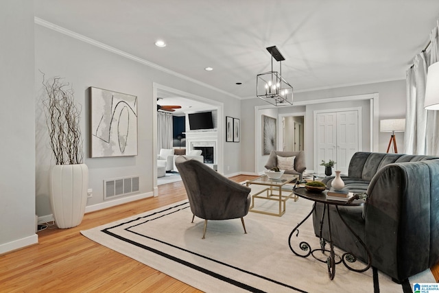 3208 N Woodridge Rd, Mountain Brook, AL 35223 - living area featuring ornamental molding, a fireplace, baseboards, light wood finished floors, and recessed lighting