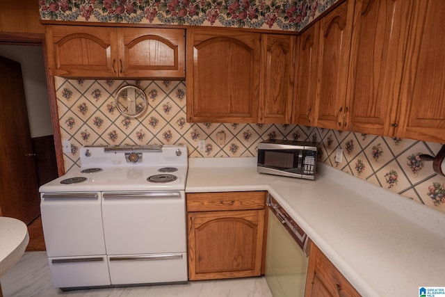 3332 Berry Dr, Hueytown, AL 35023 - kitchen with double oven range, stainless steel microwave, dishwasher, light countertops, and decorative backsplash