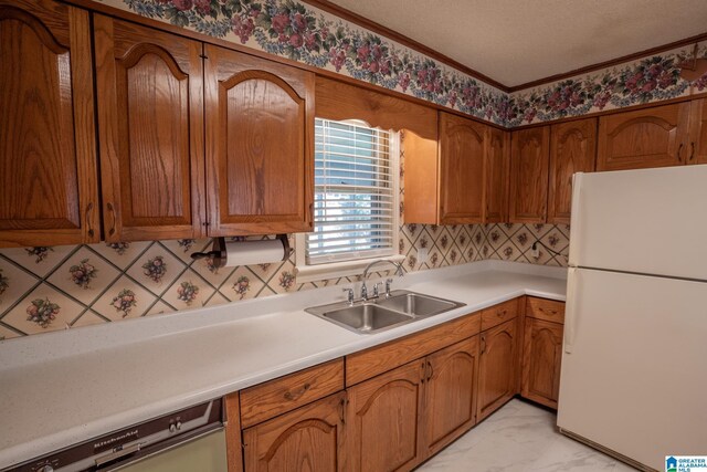 3332 Berry Dr, Hueytown, AL 35023 - kitchen with freestanding refrigerator, a sink, dishwashing machine, light marble finish flooring, and light countertops