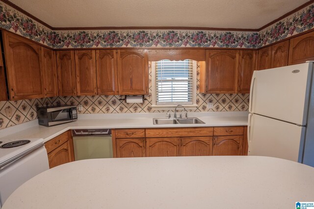 3332 Berry Dr, Hueytown, AL 35023 - kitchen with a sink, white appliances, light countertops, decorative backsplash, and brown cabinetry