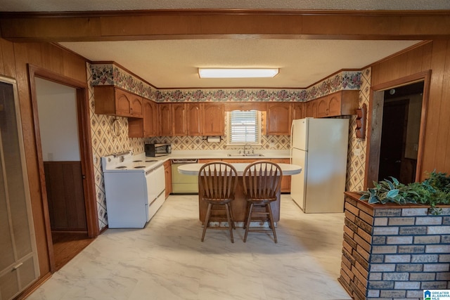 3332 Berry Dr, Hueytown, AL 35023 - kitchen with white appliances, wood walls, a sink, light countertops, and crown molding