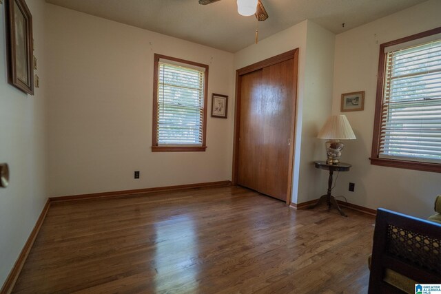 3332 Berry Dr, Hueytown, AL 35023 - unfurnished bedroom featuring multiple windows, wood finished floors, a closet, and baseboards