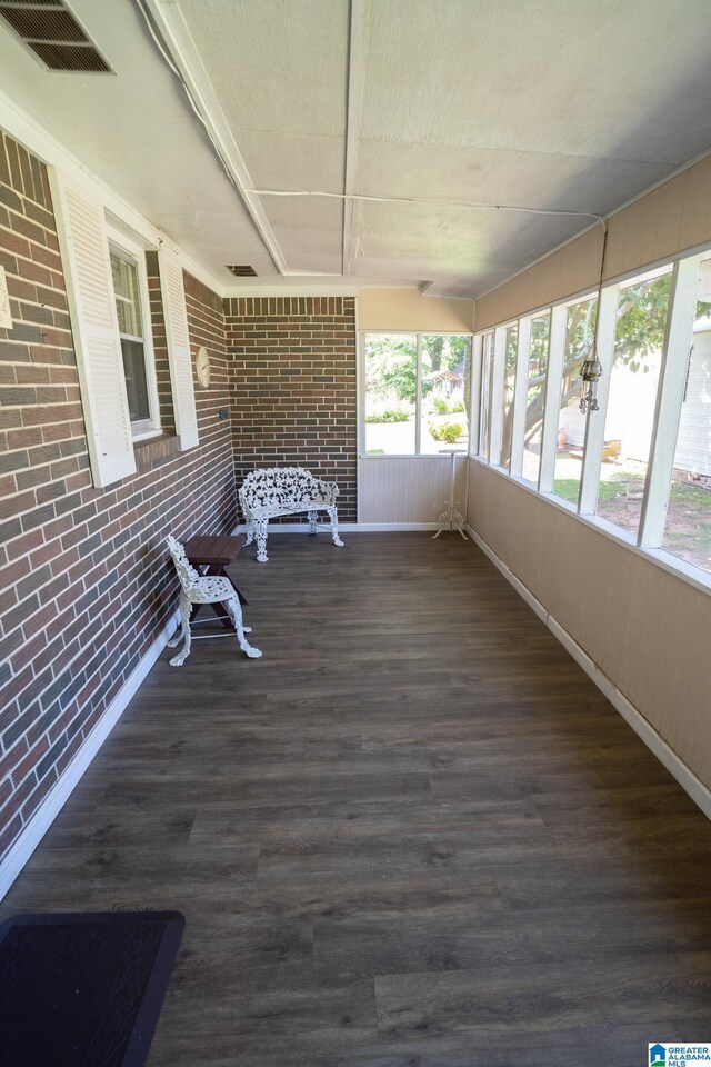 3332 Berry Dr, Hueytown, AL 35023 - unfurnished sunroom with brick wall, wood finished floors, and baseboards