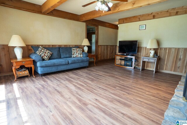3332 Berry Dr, Hueytown, AL 35023 - living room featuring beam ceiling, a ceiling fan, wood finished floors, a wainscoted wall, and wood walls