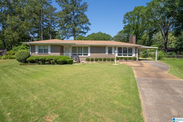 3332 Berry Dr, Hueytown, AL 35023 - view of front of property featuring a chimney, a front yard, brick siding, driveway, and an attached carport