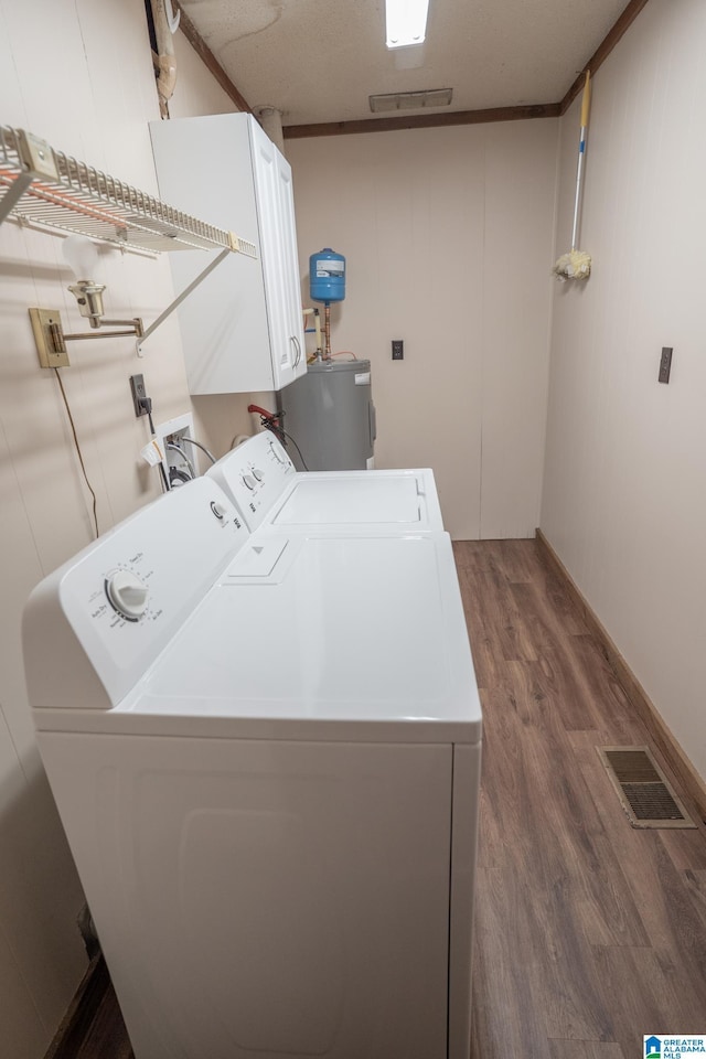 3332 Berry Dr, Hueytown, AL 35023 - laundry room featuring washer and clothes dryer, wood finished floors, water heater, and cabinet space