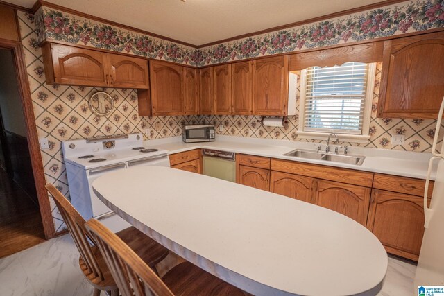 3332 Berry Dr, Hueytown, AL 35023 - kitchen with a sink, white electric range oven, dishwashing machine, a kitchen breakfast bar, and light countertops