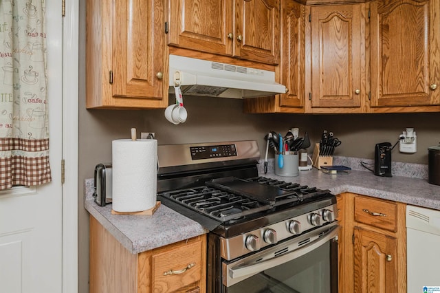 3628 Oscar Bradford Rd, Hayden, AL 35079 - kitchen featuring gas stove, under cabinet range hood, dishwasher, brown cabinetry, and light countertops