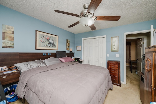 3628 Oscar Bradford Rd, Hayden, AL 35079 - bedroom featuring a closet, light carpet, a textured ceiling, and ceiling fan