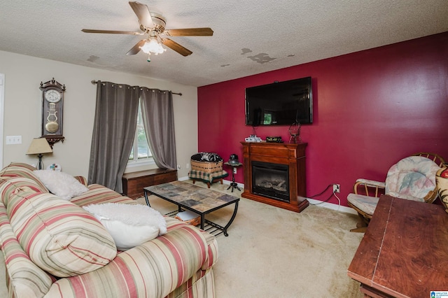 3628 Oscar Bradford Rd, Hayden, AL 35079 - carpeted living area featuring a textured ceiling, a ceiling fan, a glass covered fireplace, and baseboards
