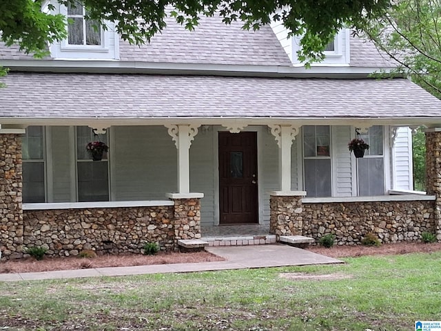 2120 Brewster Rd, Birmingham, AL 35235 - entrance to property featuring stone siding, a shingled roof, and a porch