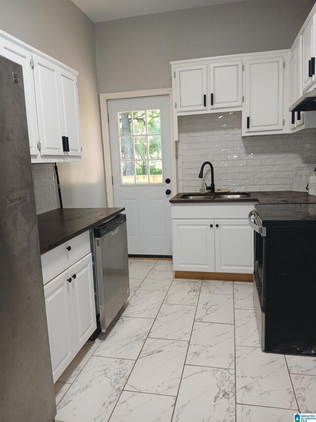 2120 Brewster Rd, Birmingham, AL 35235 - kitchen with appliances with stainless steel finishes, dark countertops, a sink, light marble finish floors, and tasteful backsplash