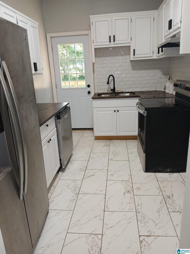 2120 Brewster Rd, Birmingham, AL 35235 - kitchen featuring appliances with stainless steel finishes, a sink, dark countertops, light marble finish floors, and decorative backsplash