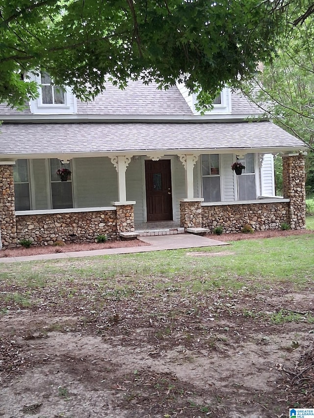 2120 Brewster Rd, Birmingham, AL 35235 - view of front of house featuring stone siding, a porch, and a shingled roof