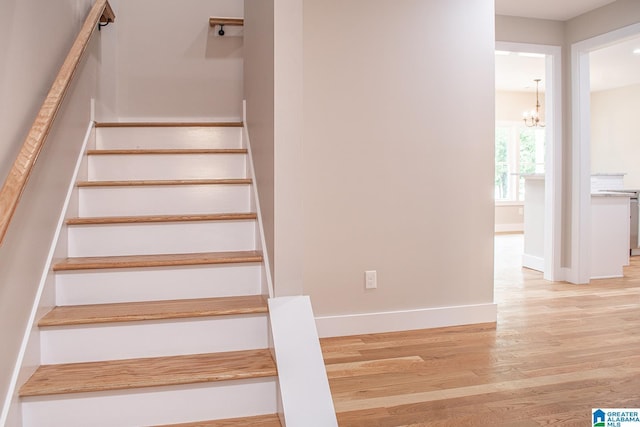 126 Harbor Pointe Dr, Talladega, AL 35160 - staircase featuring a chandelier and wood finished floors