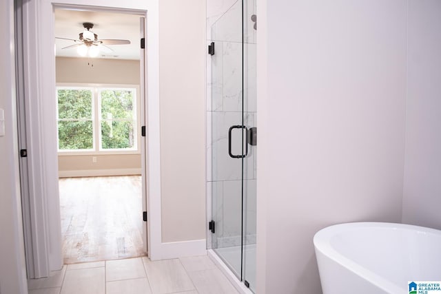 126 Harbor Pointe Dr, Talladega, AL 35160 - bathroom with ceiling fan, a freestanding bath, a stall shower, and tile patterned flooring