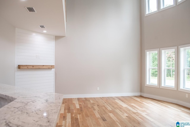 126 Harbor Pointe Dr, Talladega, AL 35160 - unfurnished living room featuring wood finished floors, recessed lighting, and a high ceiling
