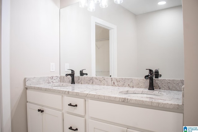 126 Harbor Pointe Dr, Talladega, AL 35160 - bathroom featuring double vanity and a chandelier
