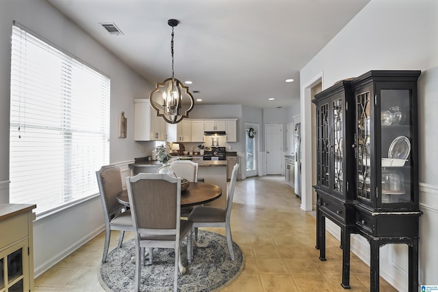 1206 Savannah Ln, Calera, AL 35040 - dining space featuring healthy amount of natural light, a chandelier, light tile patterned flooring, recessed lighting, and baseboards