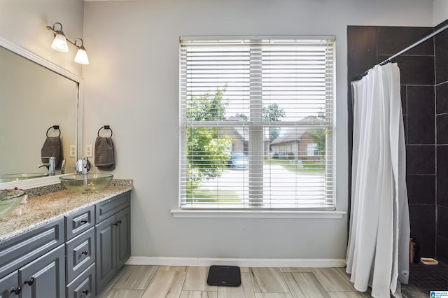 1206 Savannah Ln, Calera, AL 35040 - full bathroom featuring double vanity, a tile shower, and baseboards