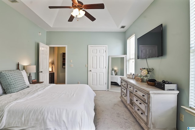 1206 Savannah Ln, Calera, AL 35040 - bedroom with a raised ceiling, light colored carpet, and a ceiling fan