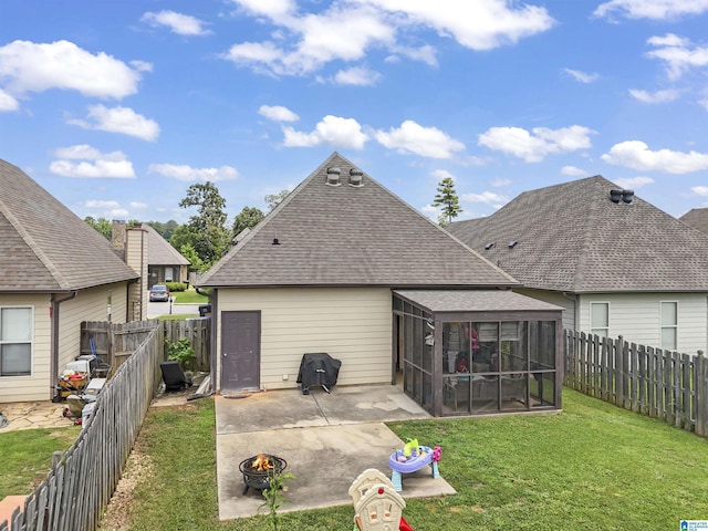 1206 Savannah Ln, Calera, AL 35040 - back of property featuring a sunroom, an outdoor fire pit, roof with shingles, and a patio