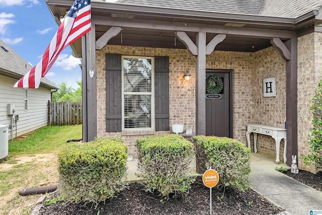 1206 Savannah Ln, Calera, AL 35040 - entrance to property featuring brick siding, a shingled roof, and covered porch
