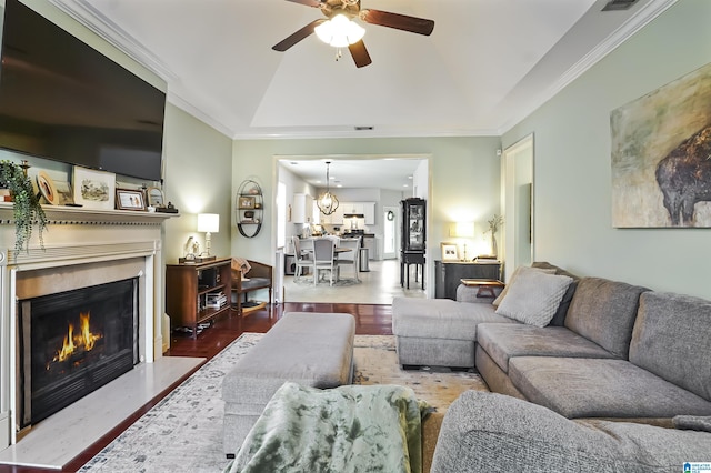 1206 Savannah Ln, Calera, AL 35040 - living room featuring ceiling fan, wood finished floors, vaulted ceiling, a fireplace with flush hearth, and ornamental molding