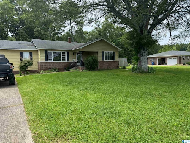 1015 Anderson Rd, Gadsden, AL 35901 - ranch-style home featuring a detached garage, a front lawn, crawl space, and a chimney