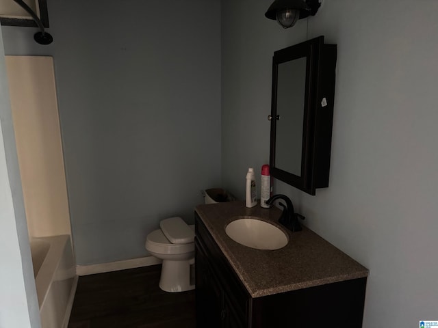 1015 Anderson Rd, Gadsden, AL 35901 - full bathroom with vanity, toilet, a bathtub, wood finished floors, and a shower