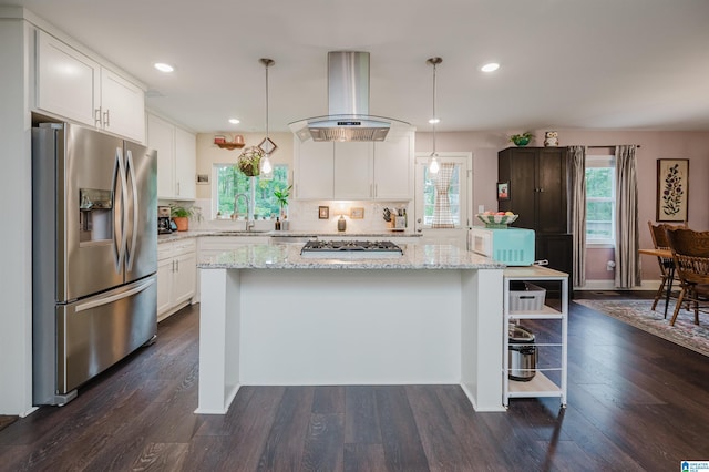 2479 Chuchura Rd, Birmingham, AL 35244 - kitchen featuring appliances with stainless steel finishes, island exhaust hood, a kitchen island, white cabinets, and decorative backsplash