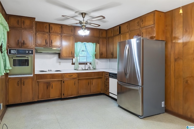 2424 Debbie Dr, Center Point, AL 35215 - kitchen with white appliances, a sink, under cabinet range hood, and brown cabinets
