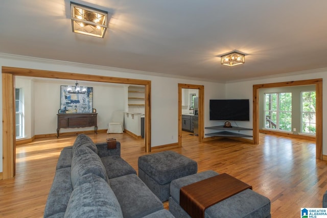 1794 Riverknolle Rd, Tallassee, AL 36078 - living area with ornamental molding, a chandelier, light wood-style flooring, and baseboards