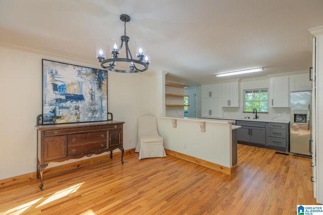 1794 Riverknolle Rd, Tallassee, AL 36078 - kitchen featuring stainless steel refrigerator with ice dispenser, a chandelier, a peninsula, light wood-style flooring, and a sink