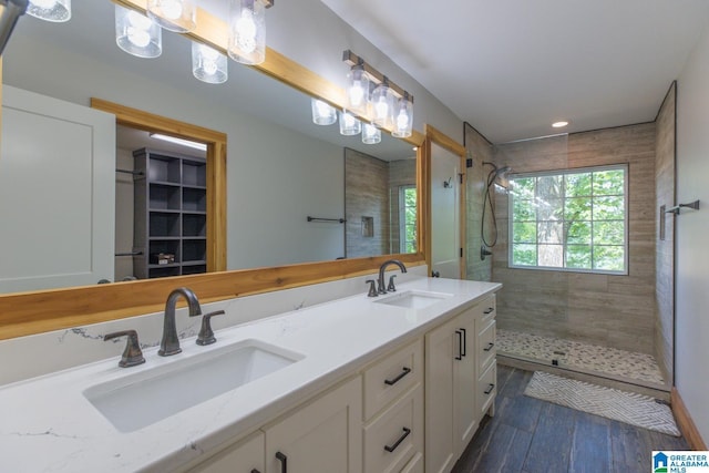 1794 Riverknolle Rd, Tallassee, AL 36078 - bathroom featuring a tile shower, wood finished floors, double vanity, and recessed lighting