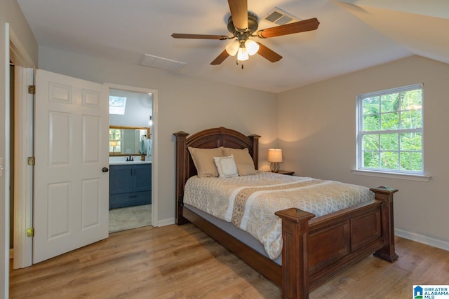 1794 Riverknolle Rd, Tallassee, AL 36078 - bedroom with light wood-type flooring, ensuite bathroom, baseboards, and lofted ceiling