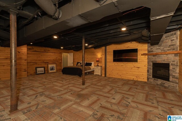 1794 Riverknolle Rd, Tallassee, AL 36078 - finished basement featuring carpet floors, wood walls, and an outdoor stone fireplace