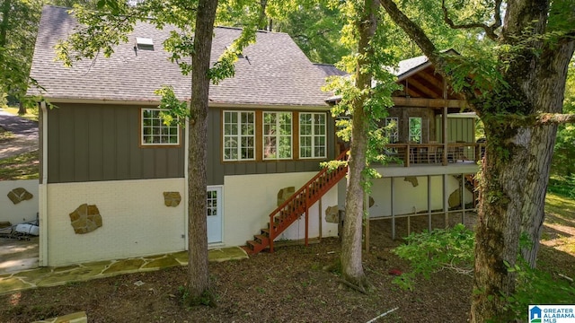 1794 Riverknolle Rd, Tallassee, AL 36078 - rear view of property featuring a shingled roof, stairs, brick siding, and board and batten siding