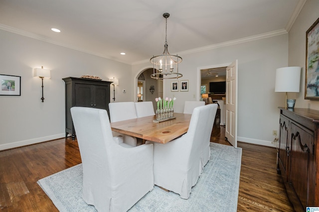 312 La Playa Pl, Homewood, AL 35209 - dining room with dark wood-type flooring, ornamental molding, a chandelier, baseboards, and arched walkways