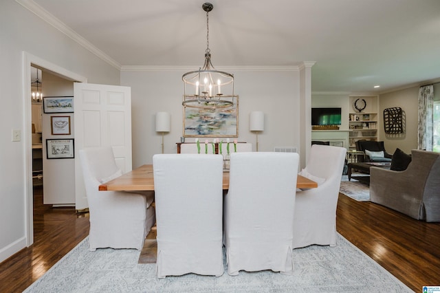 312 La Playa Pl, Homewood, AL 35209 - dining space with a chandelier, wood finished floors, ornamental molding, and a fireplace