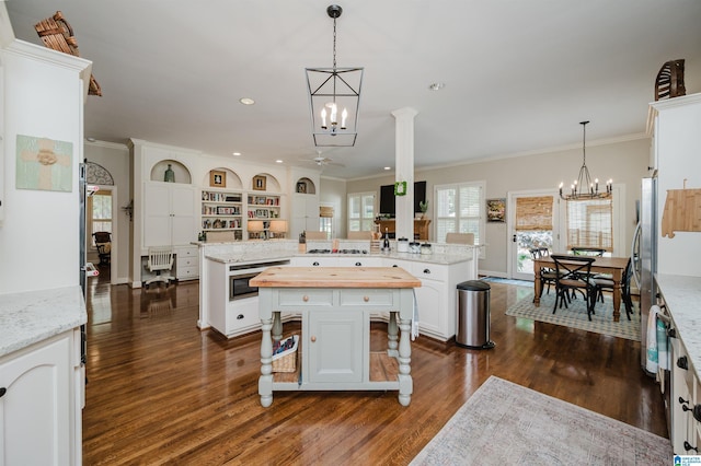 312 La Playa Pl, Homewood, AL 35209 - kitchen with a chandelier, a spacious island, dark wood-style flooring, ceiling fan, and white cabinets