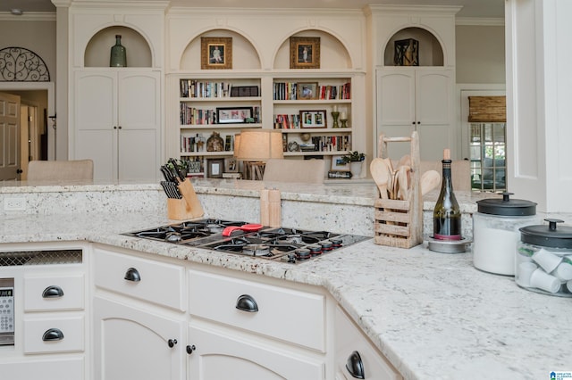 312 La Playa Pl, Homewood, AL 35209 - kitchen with ornamental molding, open shelves, black gas stovetop, white cabinets, and light stone countertops