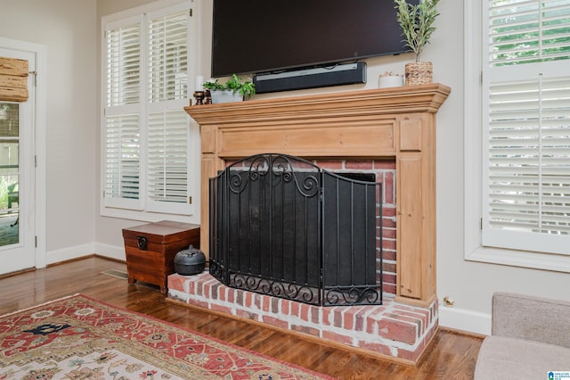 312 La Playa Pl, Homewood, AL 35209 - detailed view of a brick fireplace, wood finished floors, and baseboards