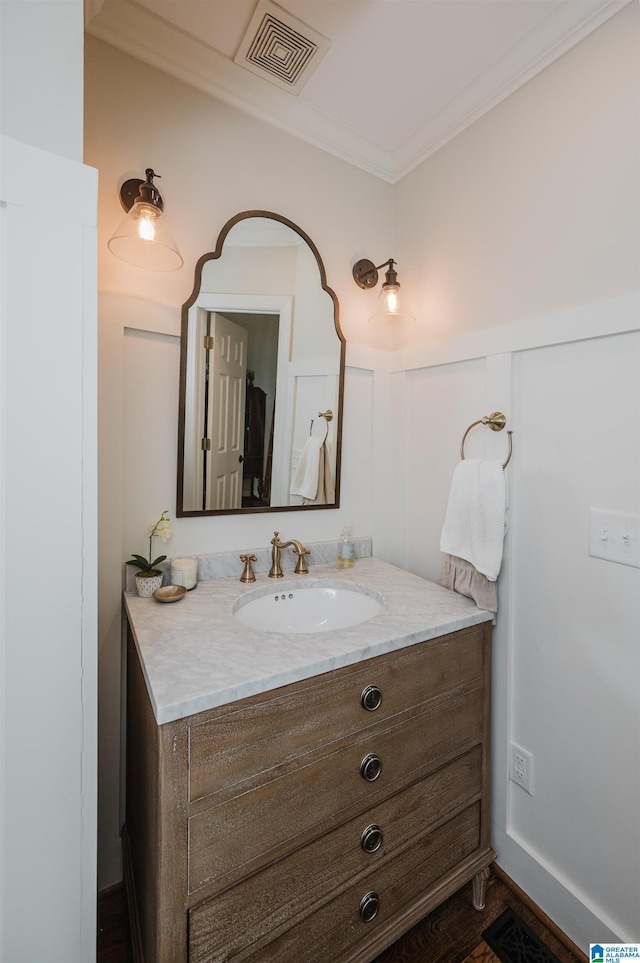 312 La Playa Pl, Homewood, AL 35209 - bathroom featuring vanity, crown molding, a decorative wall, and wainscoting